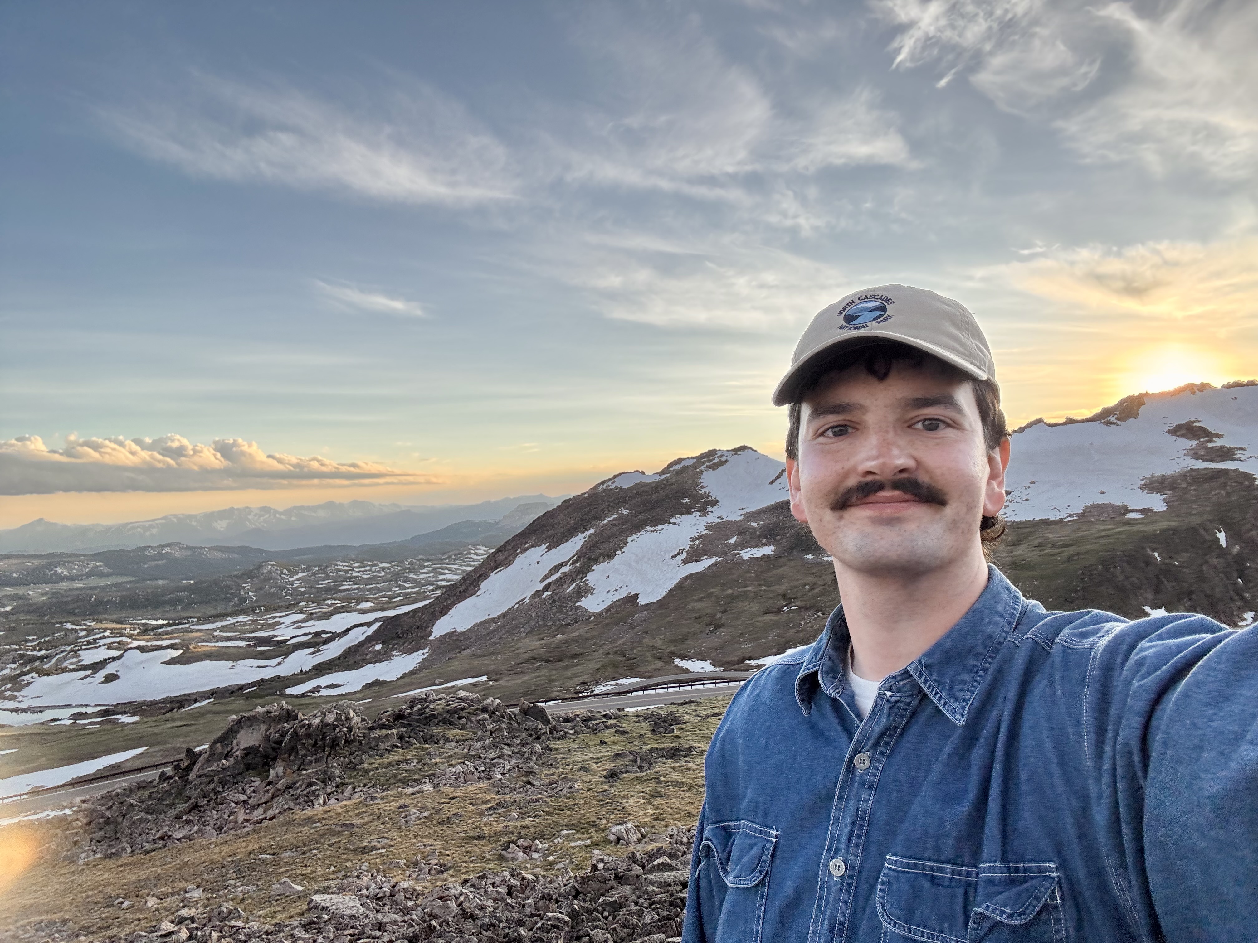Sam, founder of Mantle, at a mountain overlook at sunset